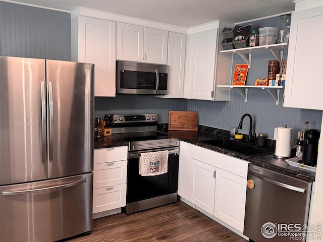 618 Melody Ln, Sterling, CO 80751 - kitchen with a sink, stainless steel appliances, dark countertops, and white cabinets