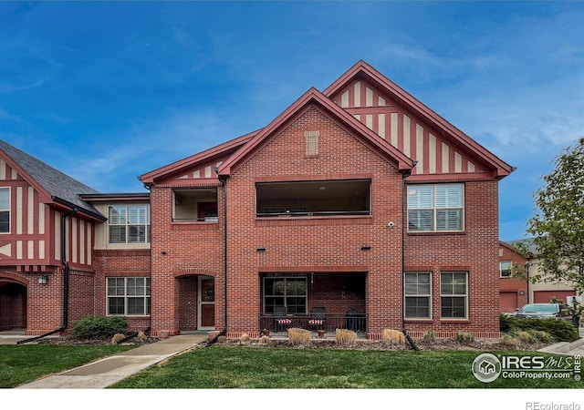 1379 Charles Dr Unit 4, Longmont, CO 80503 - english style home featuring a front yard and brick siding