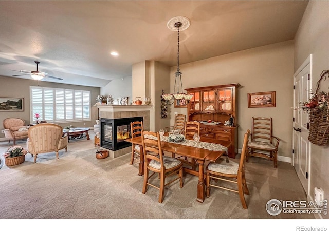 1379 Charles Dr Unit 4, Longmont, CO 80503 - dining area with a ceiling fan, a tile fireplace, carpet, and baseboards