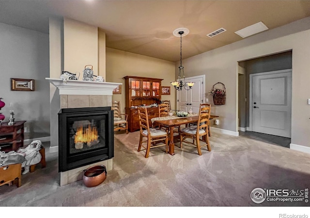 1379 Charles Dr Unit 4, Longmont, CO 80503 - dining room with carpet flooring, a tiled fireplace, visible vents, and baseboards