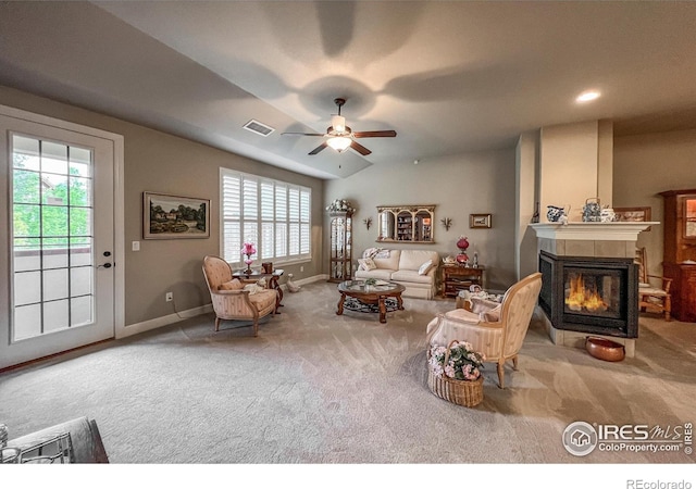 1379 Charles Dr Unit 4, Longmont, CO 80503 - living area featuring carpet, plenty of natural light, a tiled fireplace, and visible vents