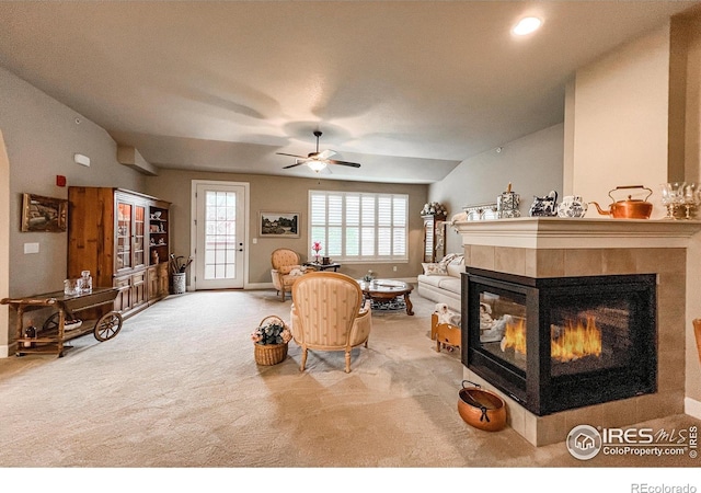 1379 Charles Dr Unit 4, Longmont, CO 80503 - carpeted living room with a ceiling fan, lofted ceiling, a tiled fireplace, and baseboards