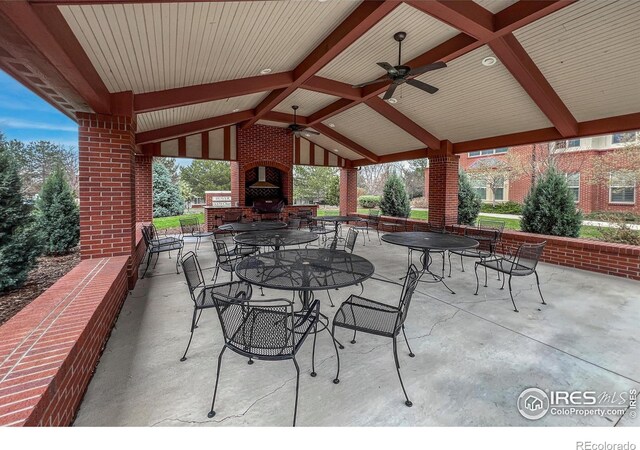1379 Charles Dr Unit 4, Longmont, CO 80503 - view of patio featuring outdoor dining space, ceiling fan, and an outdoor brick fireplace