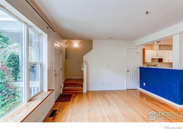 3840 Colorado Ave Unit D, Boulder, CO 80303 - unfurnished living room with baseboards, visible vents, and light wood-type flooring