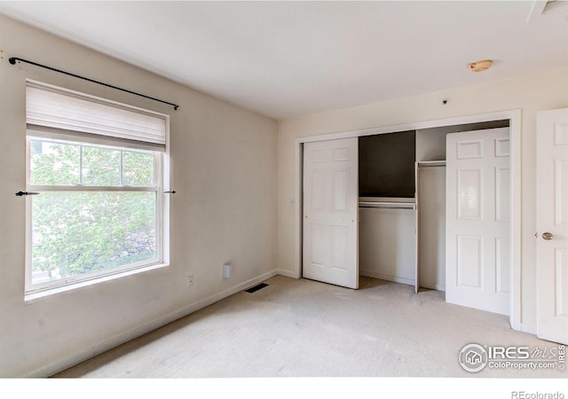 3840 Colorado Ave Unit D, Boulder, CO 80303 - unfurnished bedroom featuring baseboards, a closet, visible vents, and light colored carpet