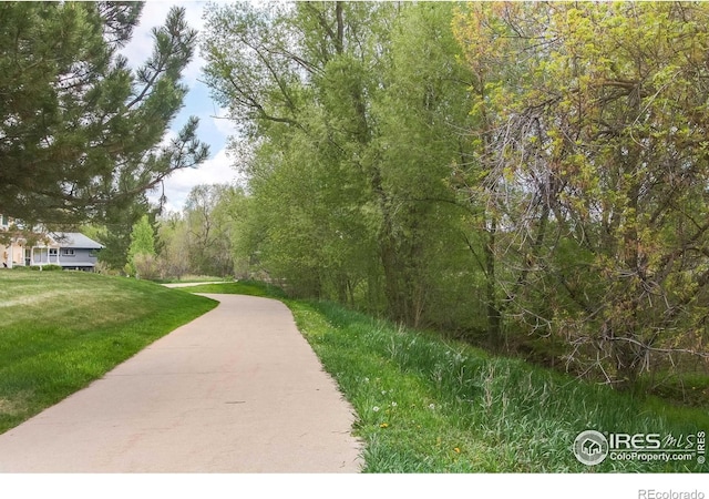 3840 Colorado Ave Unit D, Boulder, CO 80303 - view of community featuring a wooded view and a lawn