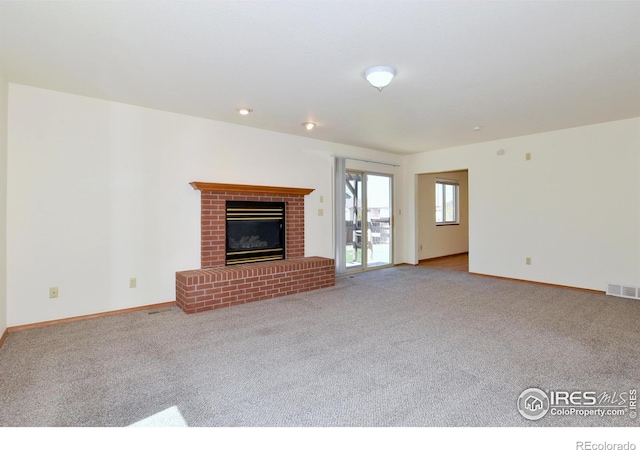 unfurnished living room featuring carpet floors, baseboards, and visible vents