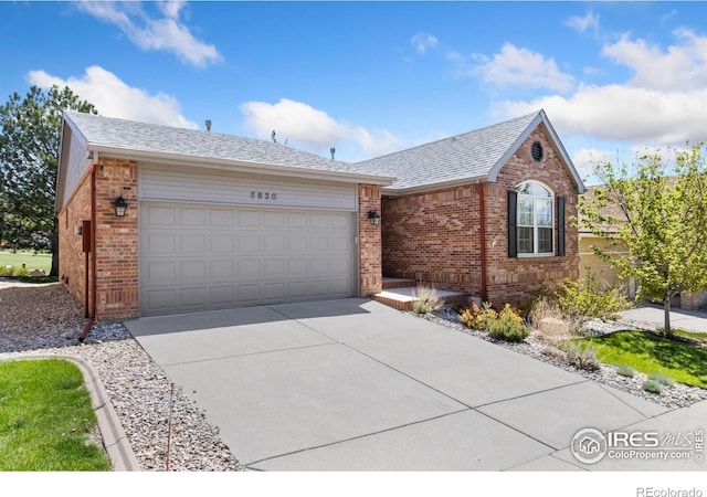 ranch-style house featuring concrete driveway, a shingled roof, brick siding, and a garage
