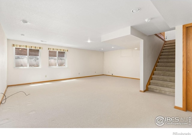 interior space with carpet, stairway, and baseboards