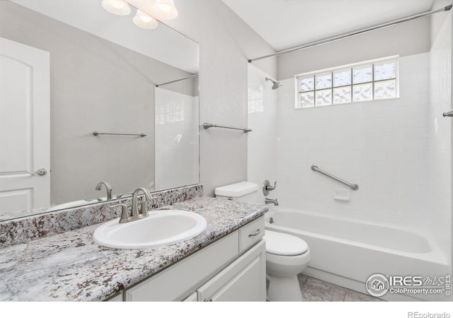 full bath featuring tile patterned floors, toilet, vanity, and washtub / shower combination