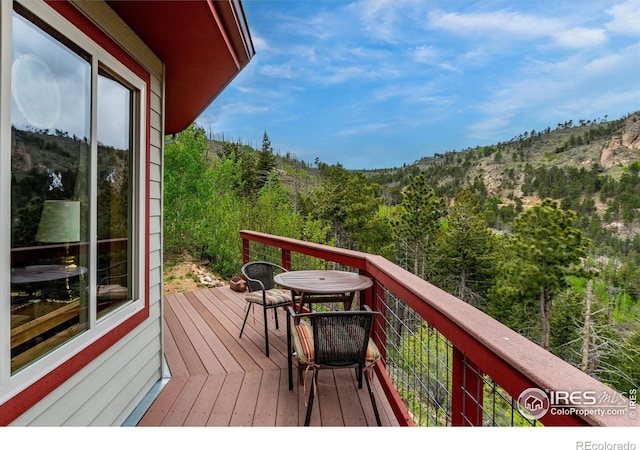 balcony featuring a view of trees