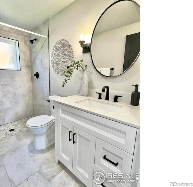 237 Clover Ln, Fort Collins, CO 80521 - bathroom with vanity, toilet, and a tile shower