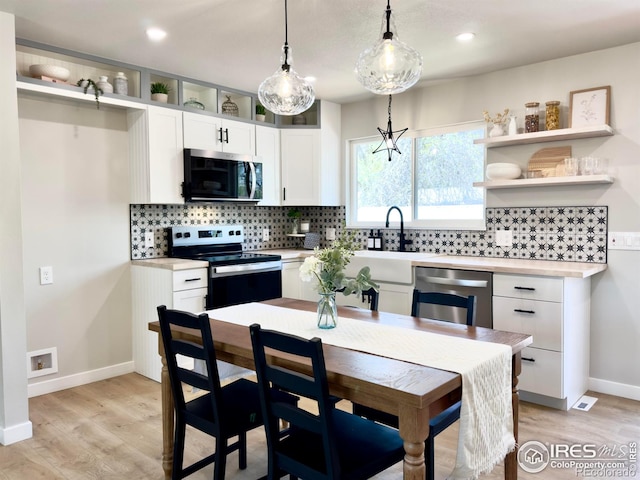 237 Clover Ln, Fort Collins, CO 80521 - kitchen with appliances with stainless steel finishes, light countertops, white cabinets, light wood-style floors, and recessed lighting