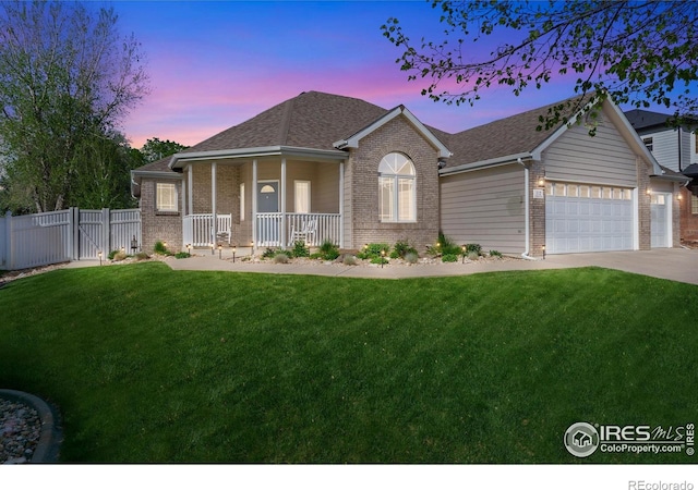112 Cobble Dr, Windsor, CO 80550 - view of front of house featuring a porch, fence, brick siding, and a front yard