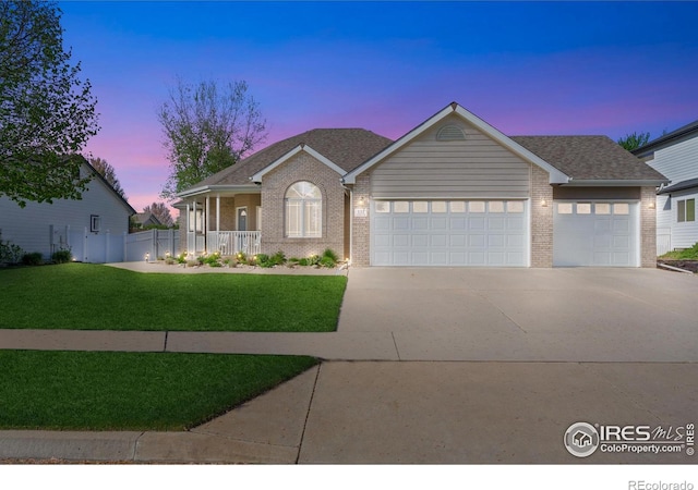 112 Cobble Dr, Windsor, CO 80550 - single story home with covered porch, a garage, a front lawn, brick siding, and driveway