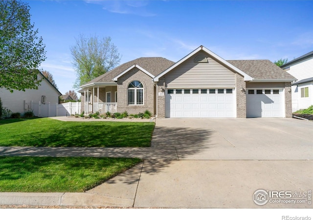 112 Cobble Dr, Windsor, CO 80550 - ranch-style home featuring driveway, a garage, brick siding, and a front yard