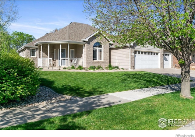 112 Cobble Dr, Windsor, CO 80550 - view of front facade featuring covered porch, a garage, concrete driveway, a front lawn, and brick siding