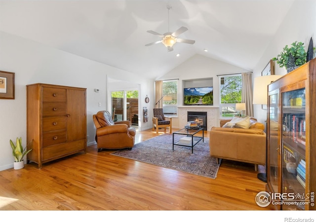 112 Cobble Dr, Windsor, CO 80550 - living area featuring wood finished floors, high vaulted ceiling, a fireplace, ceiling fan, and recessed lighting