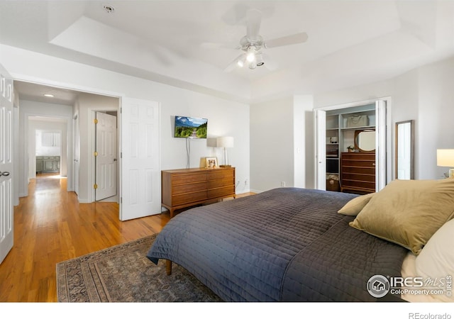 112 Cobble Dr, Windsor, CO 80550 - bedroom with baseboards, a raised ceiling, light wood-style flooring, and recessed lighting
