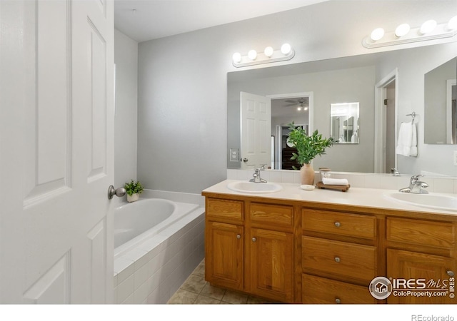 112 Cobble Dr, Windsor, CO 80550 - bathroom with double vanity, a bath, tile patterned flooring, and a sink