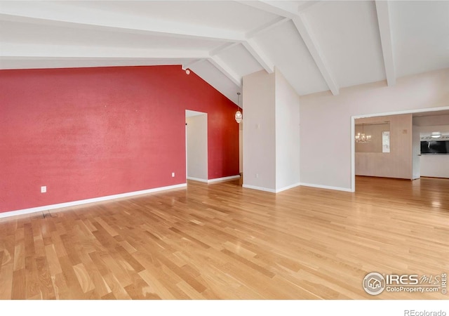 bonus room with baseboards, a notable chandelier, light wood-style floors, and vaulted ceiling with beams