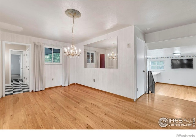 1629 Timber Ln, Boulder, CO 80304 - unfurnished dining area featuring hardwood / wood-style floors, a chandelier, and plenty of natural light