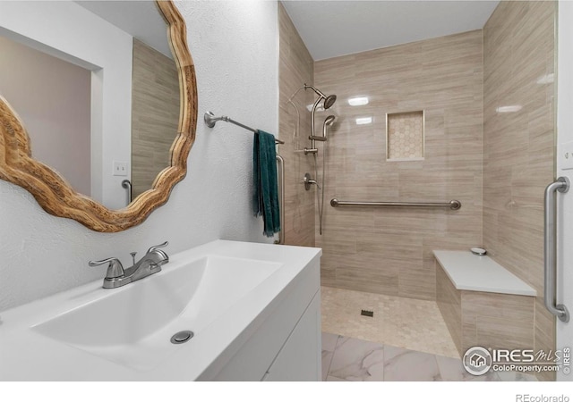 1629 Timber Ln, Boulder, CO 80304 - bathroom featuring vanity, tiled shower, and marble finish flooring