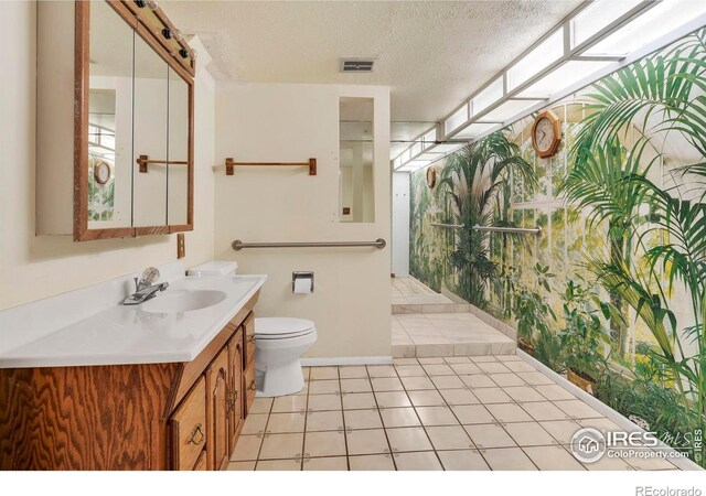 1629 Timber Ln, Boulder, CO 80304 - full bathroom with toilet, vanity, a textured ceiling, a shower, and baseboards