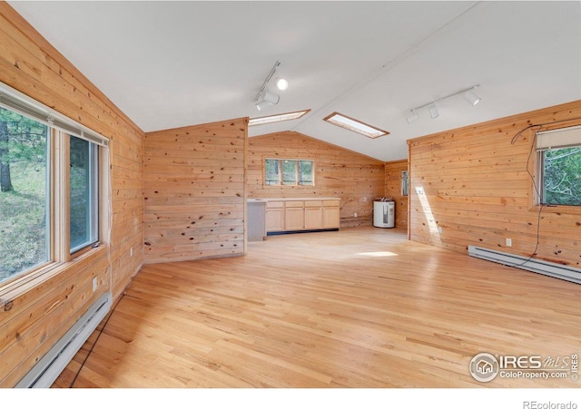 1629 Timber Ln, Boulder, CO 80304 - bonus room with lofted ceiling, wood walls, a baseboard heating unit, and light wood-type flooring