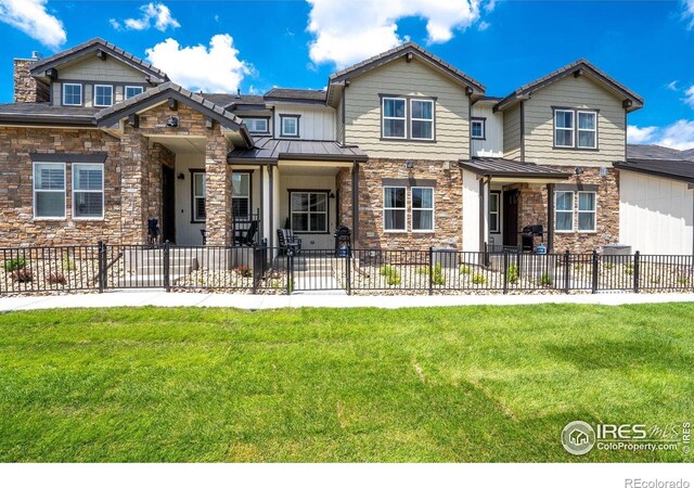 1481 Harebell St, Berthoud, CO 80513 - view of front of house featuring fence private yard, a standing seam roof, and stone siding