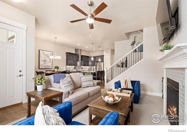 1481 Harebell St, Berthoud, CO 80513 - living area with a ceiling fan, a fireplace, stairway, baseboards, and recessed lighting