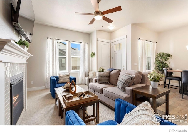 1481 Harebell St, Berthoud, CO 80513 - living room featuring baseboards, a glass covered fireplace, and ceiling fan
