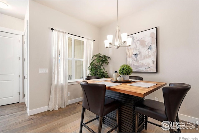 1481 Harebell St, Berthoud, CO 80513 - dining room with baseboards, a chandelier, and light wood-type flooring