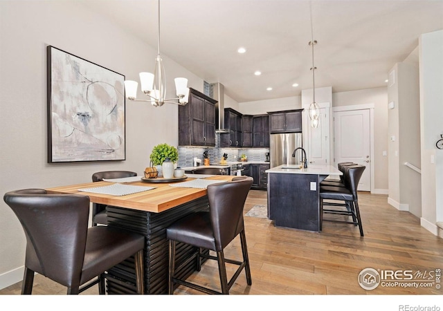 1481 Harebell St, Berthoud, CO 80513 - dining area with recessed lighting, baseboards, light wood-style flooring, and a notable chandelier