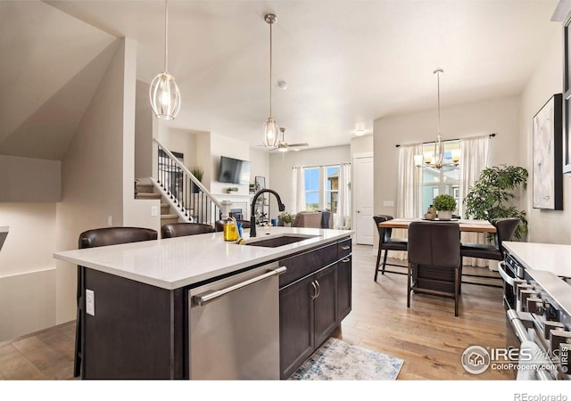 1481 Harebell St, Berthoud, CO 80513 - kitchen featuring a notable chandelier, dishwasher, dark brown cabinets, a sink, and light countertops