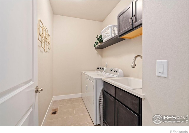 1481 Harebell St, Berthoud, CO 80513 - clothes washing area with light tile patterned floors, a sink, cabinet space, baseboards, and independent washer and dryer