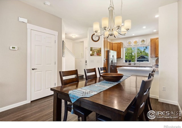 1278 Hummingbird Cir Unit D, Longmont, CO 80501 - dining area featuring dark wood-style flooring, recessed lighting, baseboards, and an inviting chandelier