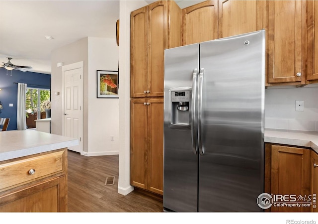 1278 Hummingbird Cir Unit D, Longmont, CO 80501 - kitchen with ceiling fan, stainless steel fridge with ice dispenser, dark wood-type flooring, brown cabinets, and light countertops