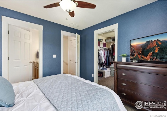 1278 Hummingbird Cir Unit D, Longmont, CO 80501 - bedroom featuring a closet, carpet flooring, ceiling fan, visible vents, and a spacious closet