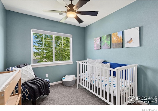 1278 Hummingbird Cir Unit D, Longmont, CO 80501 - carpeted bedroom featuring a nursery area, baseboards, and a ceiling fan
