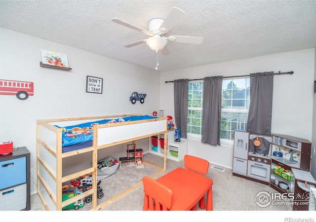 bedroom featuring carpet flooring, a textured ceiling, visible vents, and baseboards