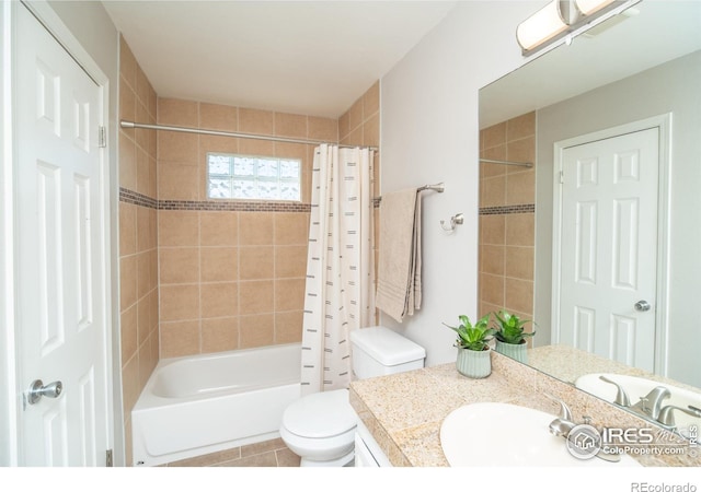 bathroom featuring tile patterned floors, toilet, vanity, and shower / bathtub combination with curtain