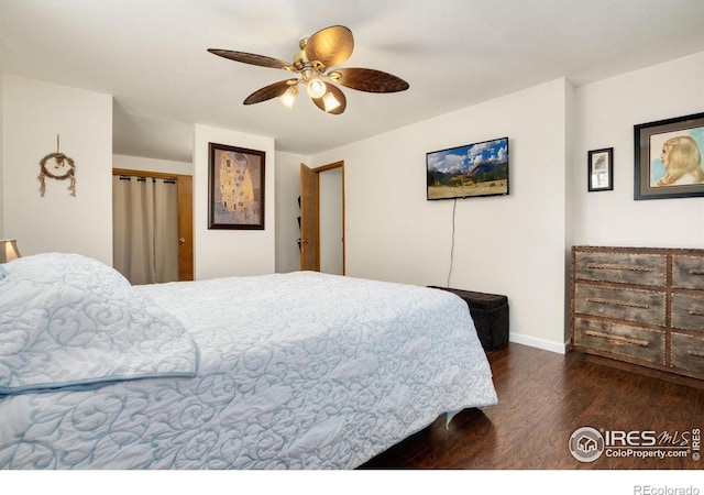 bedroom featuring baseboards, ceiling fan, and wood finished floors