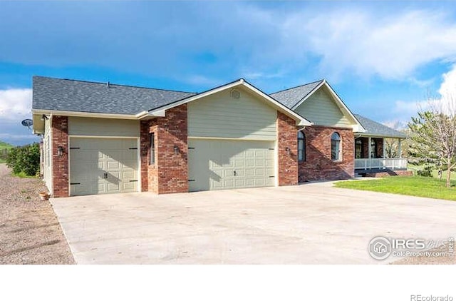 single story home with concrete driveway, brick siding, a garage, and a porch