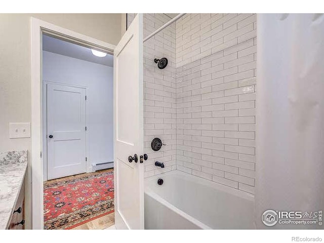 full bathroom with shower / tub combination and baseboard heating