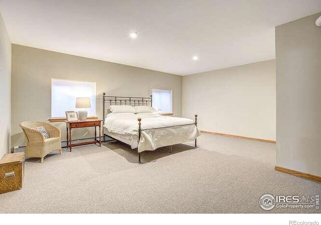 carpeted bedroom featuring baseboards, recessed lighting, and a baseboard heating unit