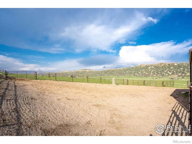 view of community featuring an enclosed riding area and a view of countryside