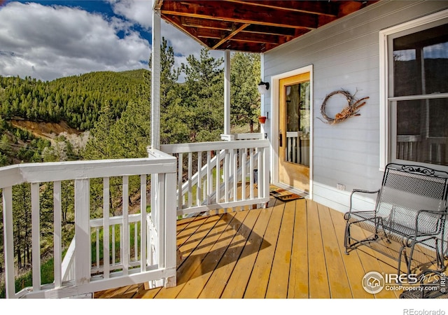 wooden deck featuring a wooded view