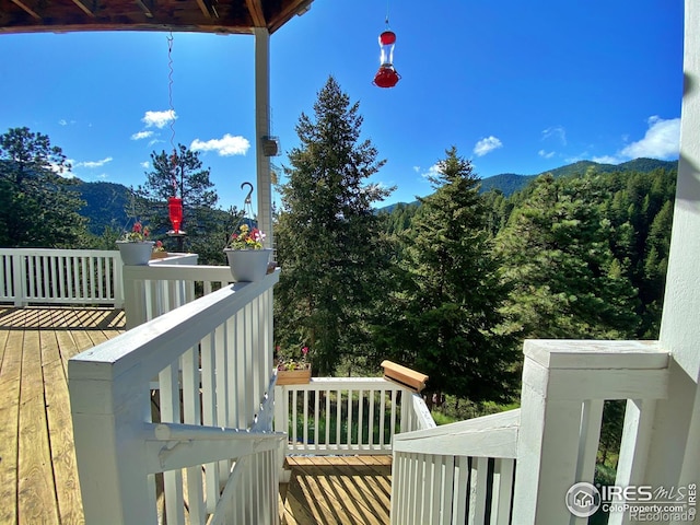 wooden deck with a mountain view