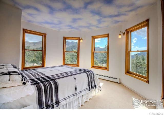 carpeted bedroom featuring a baseboard heating unit